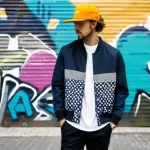 프라이탁 친환경 캡과 파타고니아 트러커 캡 추천 - **Prompt 1 (Freitag Cap - Urban Upcycling):**
"A young adult, confidently walking down a vibrant...